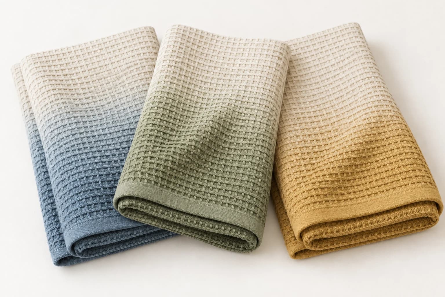 Ivory waffle towels fading gently into olive, ochre and dusty blue