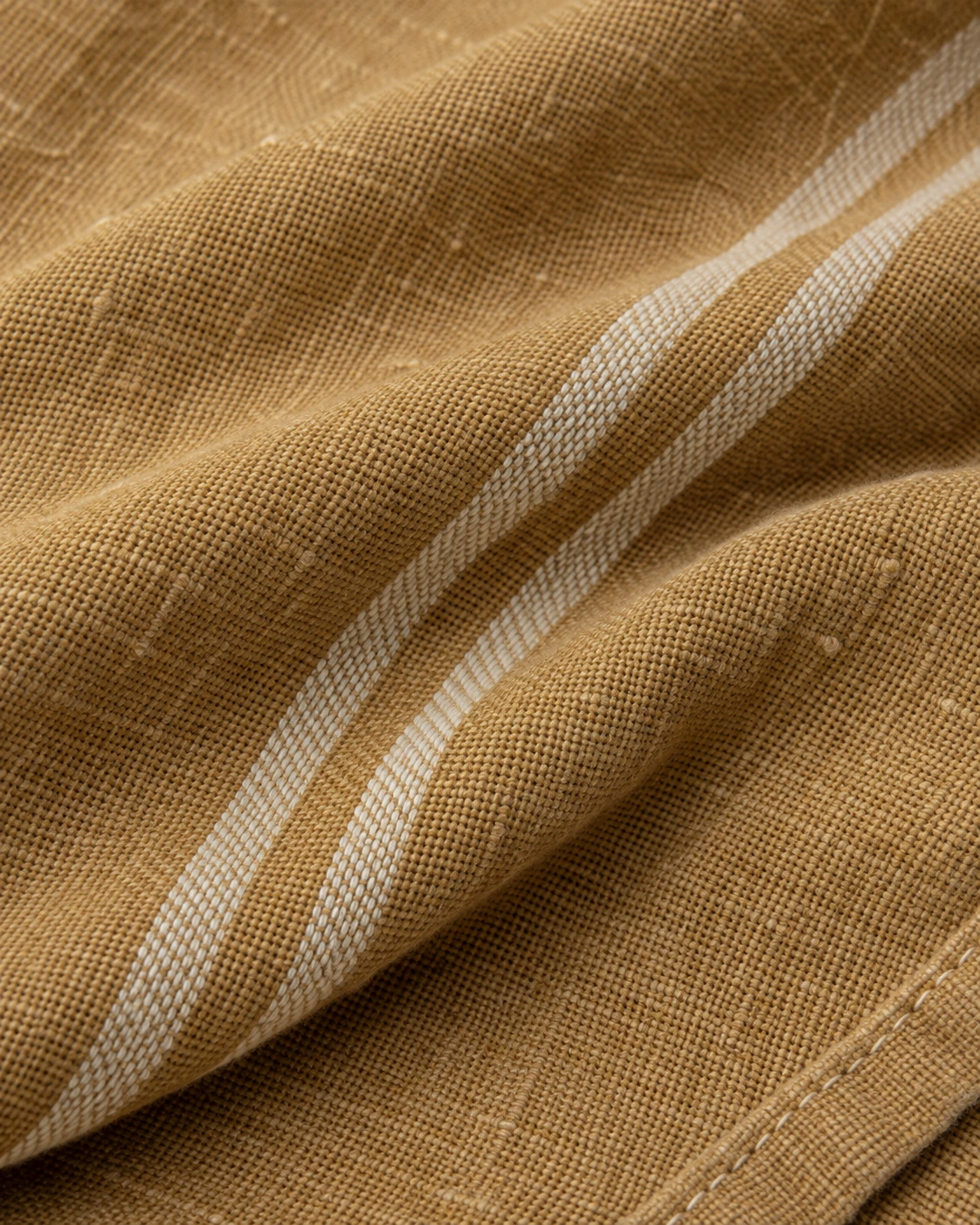 Ochre flat-weave cotton with ivory woven stripes and a thin stitched edge
