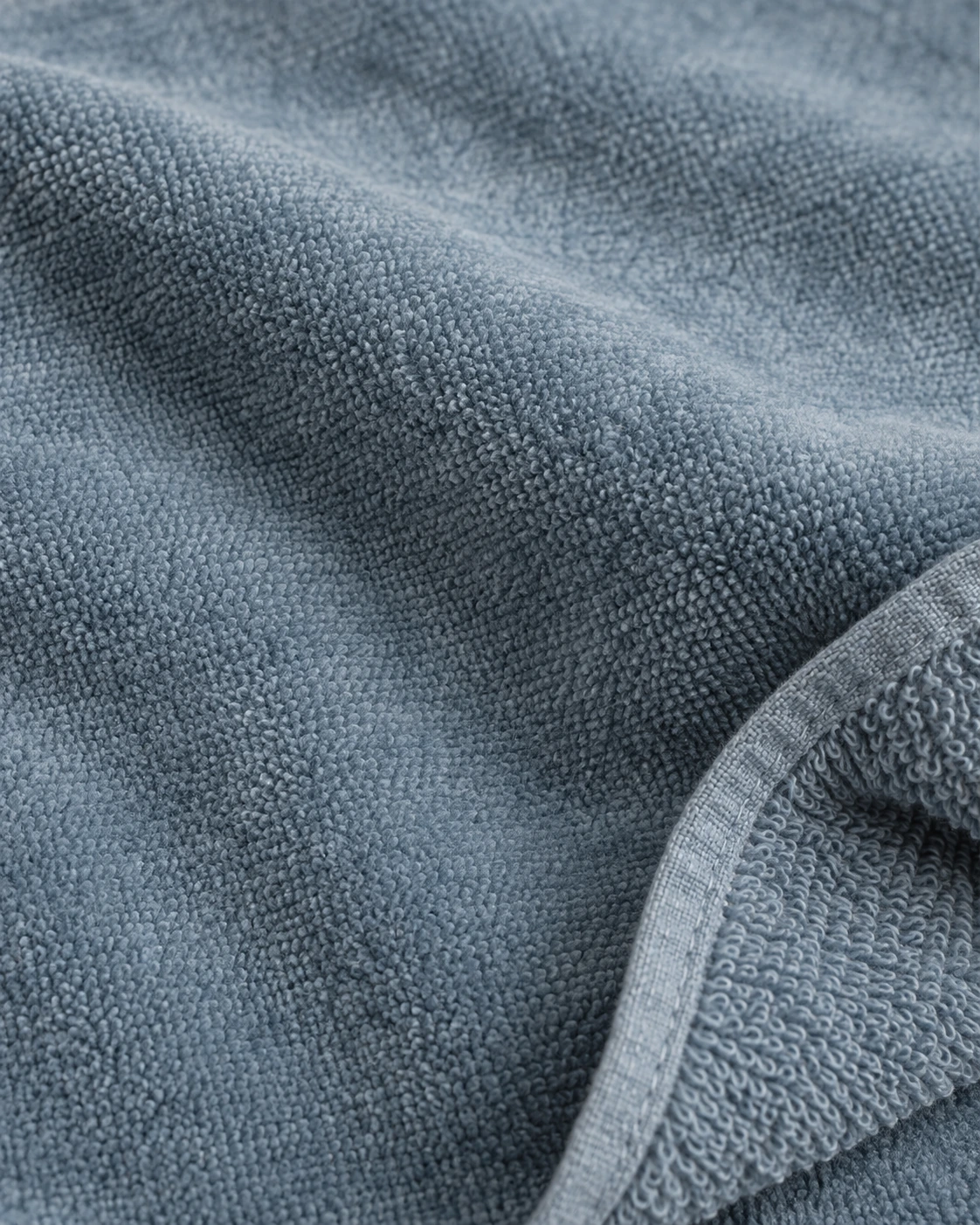 Dusty-blue cotton velour with a smooth sheared face and a turned corner showing its looped reverse