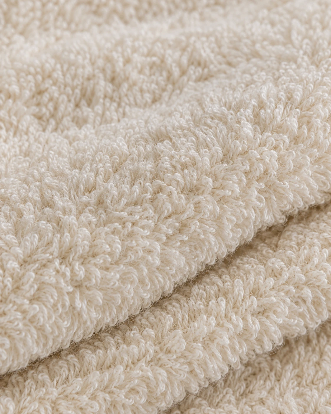 Ivory zero-twist terry with airy cotton pile and softly rounded folded layers